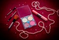 Makeup cosmetic kit on a dark red background Royalty Free Stock Photo